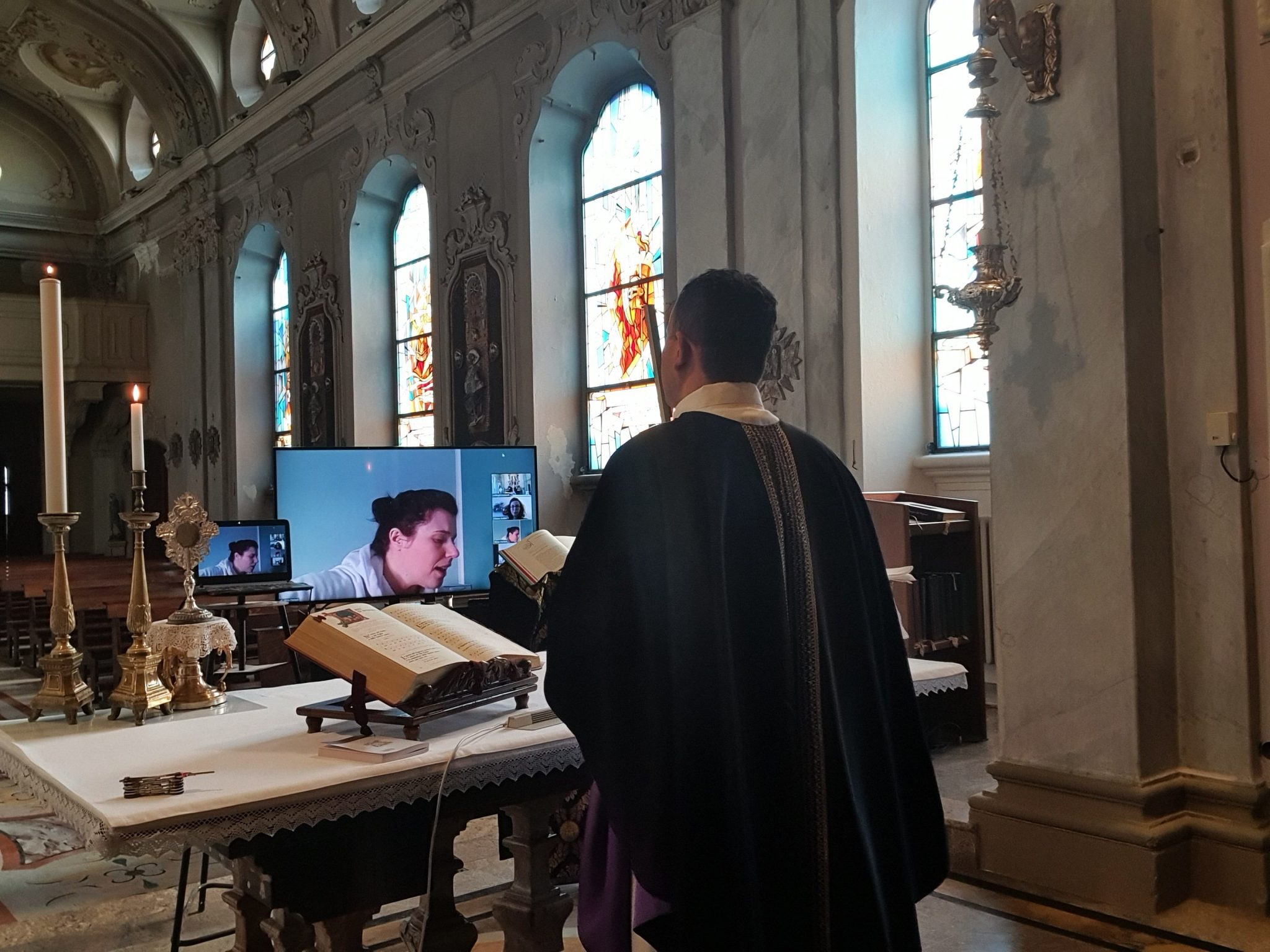 Uno dei preti smartworker intento a celebrare la messa in streaming.