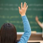 Messe a disposizione: una potenziale insegnante alza la mano in classe